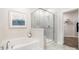 A luxurious bathroom features a separate glass enclosed shower stall and soaking tub at 7001 New Town Rd, Waxhaw, NC 28173