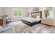 Serene bedroom retreat with a plush bed, soft rug, and plenty of natural light from the large window at 7001 New Town Rd, Waxhaw, NC 28173