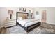 This is a spacious bedroom featuring hardwood floors and stylish interior design elements and furniture at 7001 New Town Rd, Waxhaw, NC 28173