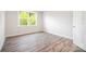 A bedroom features hardwood floors and a large window that provides natural light at 7001 New Town Rd, Waxhaw, NC 28173