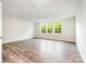 A bright and open bonus room features hardwood floors and natural light from three windows at 7001 New Town Rd, Waxhaw, NC 28173