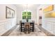 Elegant dining room with modern chandelier, wainscoting, and large window overlooking the backyard at 7001 New Town Rd, Waxhaw, NC 28173