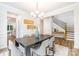 Bright dining room featuring hardwood floors, a statement chandelier, and access to the kitchen at 7001 New Town Rd, Waxhaw, NC 28173