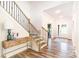 Elegant foyer with hardwood floors, staircase with iron spindles, and a stylish console table at 7001 New Town Rd, Waxhaw, NC 28173