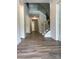 Inviting foyer featuring wood floors, a staircase with iron spindles, and an open hallway at 7001 New Town Rd, Waxhaw, NC 28173
