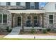 Inviting front porch with charming rocking chairs and stone accents, perfect for relaxing outdoors at 7001 New Town Rd, Waxhaw, NC 28173