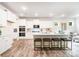 Modern kitchen with white cabinetry, stainless steel appliances, and a spacious center island with seating at 7001 New Town Rd, Waxhaw, NC 28173