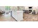 Kitchen island with sink and stainless steel dishwasher and living room in background at 7001 New Town Rd, Waxhaw, NC 28173
