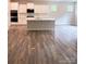 Bright, spacious kitchen with an island, recessed lighting, white cabinets, and stainless steel appliances at 7001 New Town Rd, Waxhaw, NC 28173