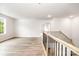A spacious second-floor landing with hardwood floors and natural light from a large window at 7001 New Town Rd, Waxhaw, NC 28173