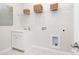 Functional laundry room with ample storage, including overhead baskets, a utility sink, and convenient appliance hookups at 7001 New Town Rd, Waxhaw, NC 28173