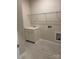 Well-lit laundry room featuring a sink with cabinet and convenient overhead shelving at 7001 New Town Rd, Waxhaw, NC 28173