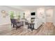 Comfortable living room with sofas, fireplace, and large windows for natural light at 7001 New Town Rd, Waxhaw, NC 28173