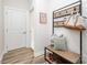 Charming mudroom area with coat rack, bench, and storage basket, creating a welcoming and organized entryway at 7001 New Town Rd, Waxhaw, NC 28173