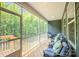 Inviting screened porch with comfortable seating, perfect for relaxing and enjoying the outdoors at 7001 New Town Rd, Waxhaw, NC 28173