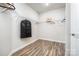 A walk-in closet features hardwood floors and metal racks for ample storage at 7001 New Town Rd, Waxhaw, NC 28173