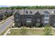 Aerial view of a brick townhome community showcasing well-maintained lawns and mature trees at 7957 Reunion Row Dr, Charlotte, NC 28277