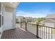 Balcony view of a neighborhood streetscape showcasing well-maintained homes and mature trees under a bright blue sky at 7957 Reunion Row Dr, Charlotte, NC 28277
