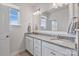Bathroom with a double vanity, granite countertop, and ample natural light from the window at 7957 Reunion Row Dr, Charlotte, NC 28277