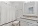 Bright bathroom featuring a granite-topped vanity, white cabinets and a shower with modern fixtures at 7957 Reunion Row Dr, Charlotte, NC 28277