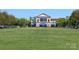 Expansive green space and commercial building, perfect for outdoor events and community gatherings at 7957 Reunion Row Dr, Charlotte, NC 28277