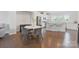 Light-filled dining area with hardwood floors and an eat-in kitchen featuring stainless steel appliances and a bar at 7957 Reunion Row Dr, Charlotte, NC 28277
