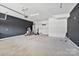 Spacious garage with a black accent wall, shelving, and ample storage space at 7957 Reunion Row Dr, Charlotte, NC 28277