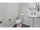 Clean half-bath featuring a modern pedestal sink and updated fixtures, perfect for guests at 7957 Reunion Row Dr, Charlotte, NC 28277