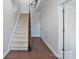 Bright hallway with hardwood floors, a staircase, and white trim, offering a welcoming entrance at 7957 Reunion Row Dr, Charlotte, NC 28277