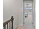 Hallway leading to a bedroom, with a view of natural light and a glimpse of the space beyond at 7957 Reunion Row Dr, Charlotte, NC 28277