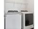 Laundry room featuring newer, white, front-load, Samsung washer and dryer, and custom shelving above at 7957 Reunion Row Dr, Charlotte, NC 28277
