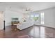 Spacious living room features hardwood floors, lots of natural light, neutral decor, and access to a balcony at 7957 Reunion Row Dr, Charlotte, NC 28277