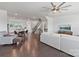Open concept living room with hardwood floors and views into the kitchen and dining area, and staircase at 7957 Reunion Row Dr, Charlotte, NC 28277