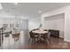 Open-concept living room with dark hardwood floors, a comfortable seating area, and bright natural light at 7957 Reunion Row Dr, Charlotte, NC 28277