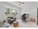 Bright home office with large windows, neutral decor, and comfortable seating area at 7957 Reunion Row Dr, Charlotte, NC 28277