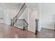 View of the property's staircase featuring stained wood handrails with decorative iron spindles and hardwood floors at 7957 Reunion Row Dr, Charlotte, NC 28277