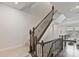 Elegant staircase with wrought iron railings and carpeted steps leading to the upper level of the home at 7957 Reunion Row Dr, Charlotte, NC 28277