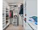 Spacious walk-in closet with custom white shelving and drawers for optimal organization and storage at 7957 Reunion Row Dr, Charlotte, NC 28277
