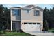 Charming two-story home featuring gray siding, brick accents, and an attached two-car garage at 811 Blue Canyon Dr, York, SC 29745