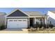 Charming home featuring a two-car garage and beautifully landscaped front yard at 1030 Mapletree Ln, Indian Trail, NC 28079
