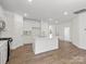 Bright, open kitchen with white cabinets, a center island, and modern finishes at 1030 Mapletree Ln, Indian Trail, NC 28079