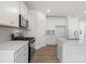 Well-lit kitchen with stainless steel appliances, white cabinets, and a tile backsplash at 1030 Mapletree Ln, Indian Trail, NC 28079