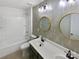 Stylish bathroom with vanity, decorative mirrors, and a shower-tub combo at 1082 Wallace Lake Rd, Fort Mill, SC 29707