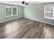 Bright, airy bedroom with neutral walls and hardwood floors featuring two windows allowing natural light at 1082 Wallace Lake Rd, Fort Mill, SC 29707