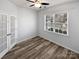 Bright bedroom features natural light from window and complemented by modern wood-look flooring and double doors at 1082 Wallace Lake Rd, Fort Mill, SC 29707