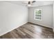 Cozy bedroom featuring wood-look floors, a ceiling fan, and a window at 1082 Wallace Lake Rd, Fort Mill, SC 29707