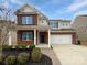 Beautiful two-story home showcasing brick and vinyl siding with a well-maintained lawn and two-car garage at 1082 Wallace Lake Rd, Fort Mill, SC 29707