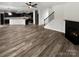 Spacious open-concept layout featuring fireplace, staircase, wood floors and seamlessly connecting the living area to the kitchen at 1082 Wallace Lake Rd, Fort Mill, SC 29707