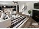 Bright living room with a cozy fireplace, open to the kitchen and with staircase access to upper level at 1082 Wallace Lake Rd, Fort Mill, SC 29707