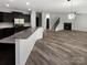 Spacious open floorplan with a kitchen island, wood-look floors and a fireplace at 1082 Wallace Lake Rd, Fort Mill, SC 29707